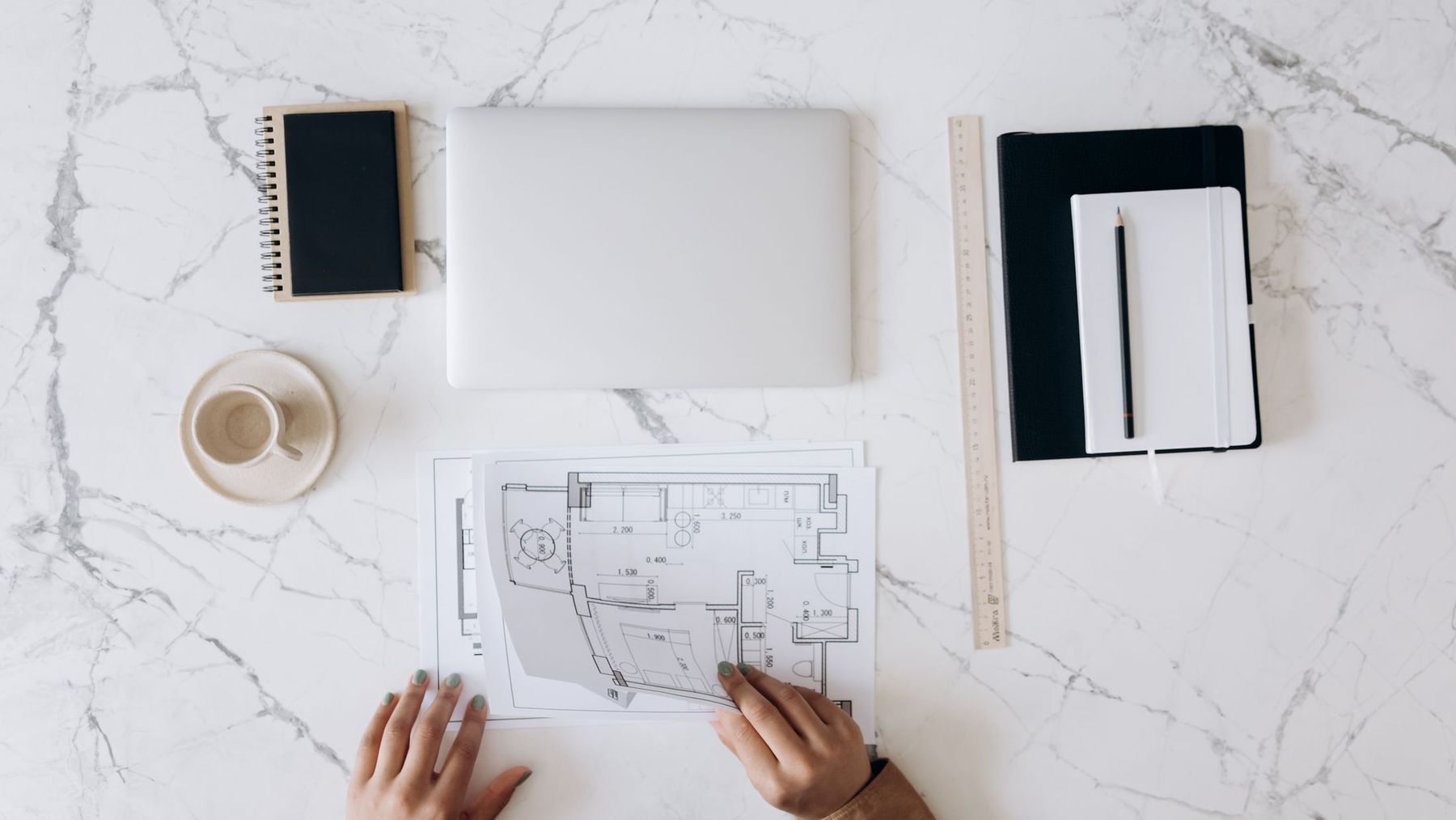 Hand-marked plans and drawings spread on a table