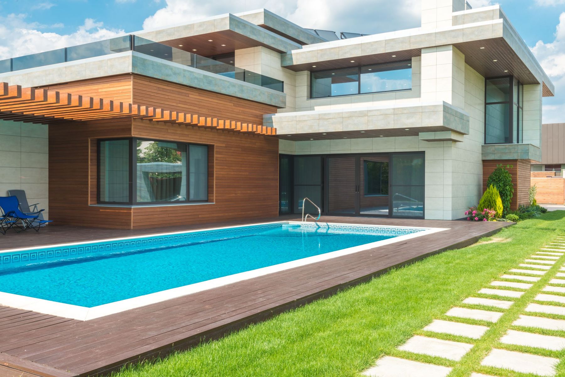 A warm home exterior with a backyard pool